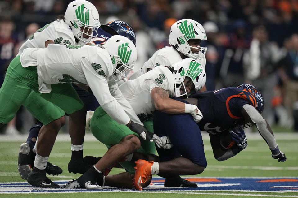 UTSA running back Kevorian Barnes, right, is stopped by North Texas linebacker Larry Nixon III (3) on a run during the second half of an NCAA college football game for the Conference USA championship in San Antonio, Friday, Dec. 2, 2022. (AP Photo/Eric Gay)