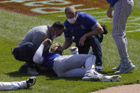 Kansas City Royals' Hunter Dozier is attended to after colliding along the first base line with Chicago White Sox's Jose Abreu in the second inning of the first game of a baseball doubleheader Friday, May 14, 2021, in Chicago. (AP Photo/Charles Rex Arbogast)