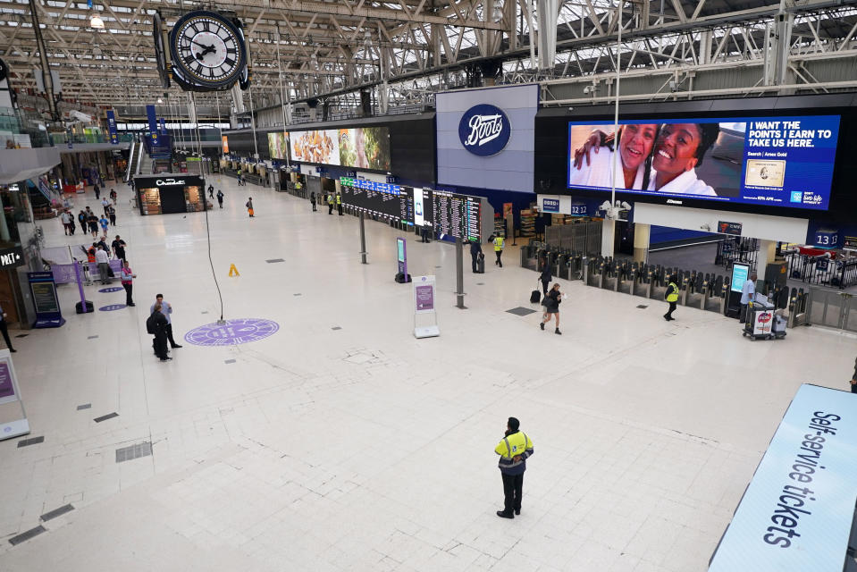 Few passengers walk at Waterloo East station as train services continue to be disrupted following the nationwide strike by members of the Rail, Maritime and Transport union along with London Underground workers in a bitter dispute over pay, jobs and conditions, in London, Thursday, June 23, 2022. (Victoria Jones/PA via AP)