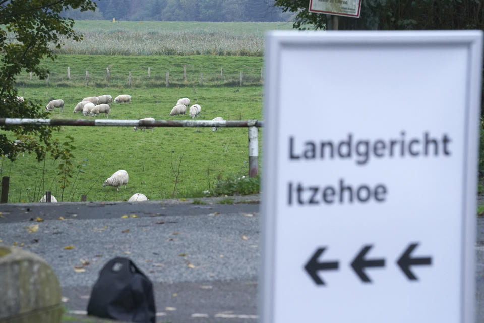 "Itzehoe District Court" is written on a signpost in front of the entrance to the China Logistic Center, where the Itzehoe District Court is hearing the trial of a 96-year-old former secretary to the SS commander of the Stutthof concentration campin Itzehoe, Germany, Tuesday, Oct. 19, 2021. The woman is charged of more than 11,000 counts of accessory to murder. Prosecutors argue that the 96-year-old woman was part of the apparatus that helped the Nazi camp function more than 75 years ago. (Markus Brandt/DPA via AP)