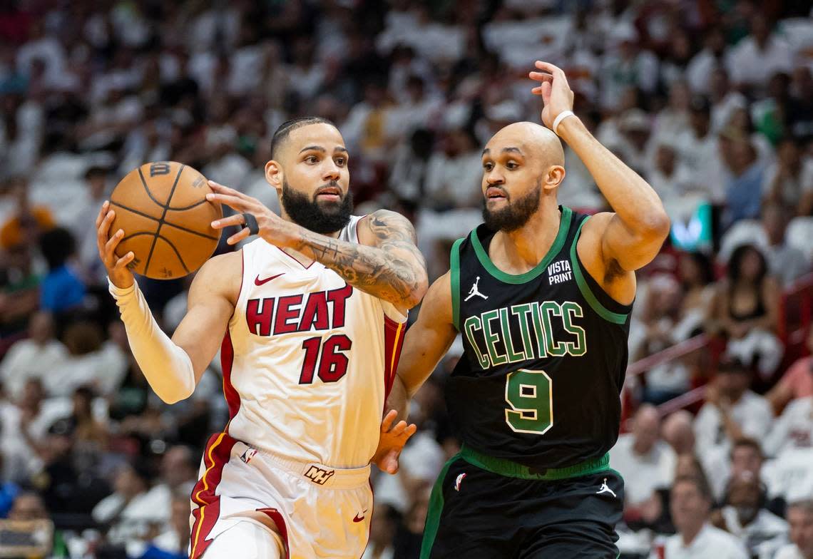 Miami Heat forward Caleb Martin (16) drives the ball as Boston Celtics guard Derrick White (9) defends in the first half of Game 4 of an NBA basketball first-round playoff series at Kaseya Center on April 29, 2024, in Miami.