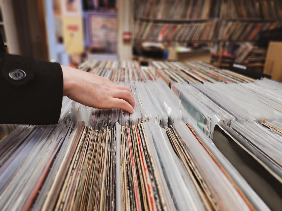 Someone rifling through stacks of LPs in a store