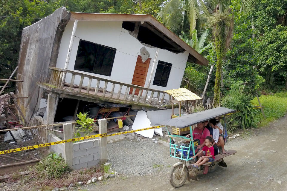 TOPSHOT - A motorist drives past a destroyed house after a large earthquake that hit Surigao City, in southern island of Mindanao on July 15, 2019. - Fifty-one people were injured and several homes, churches and other buildings damaged on Saturday when an earthquake sent terrified residents of the southern Philippines fleeing their homes before dawn, police said. (Photo by ERWIN MASCARINAS / AFP) (Photo credit should read ERWIN MASCARINAS/AFP/Getty Images)