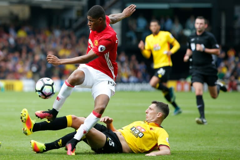 Manchester United's Marcus Rashford (top) is tackled by Watford's Craig Cathcart during the Premier League match at Vicarage Road Stadium in Watford, on September 18, 2016