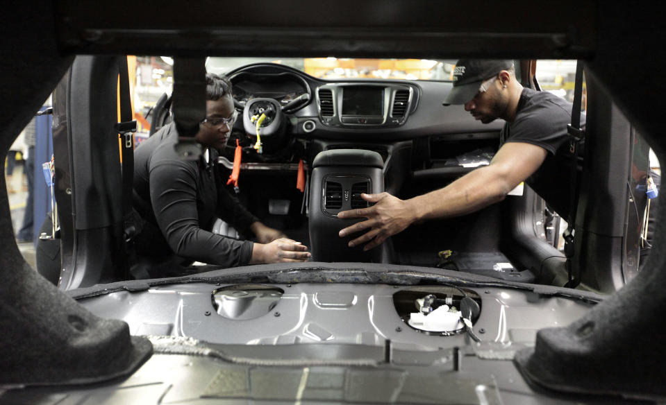 In this March 14, 2014 photo, assembly line workers build a 2015 Chrysler 200 automobile at the Sterling Heights Assembly Plant in Sterling Heights, Mich. Many economists say 2014 will be the year the economic recovery from the Great Recession finally achieves the robust growth that’s needed to accelerate hiring and reduce still-high unemployment. (AP Photo/Paul Sancya)