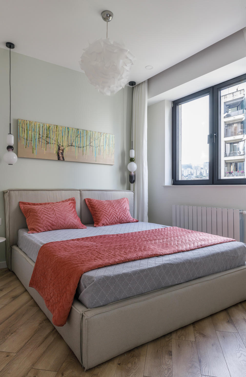 A small bedroom with pull out drawers under the bed