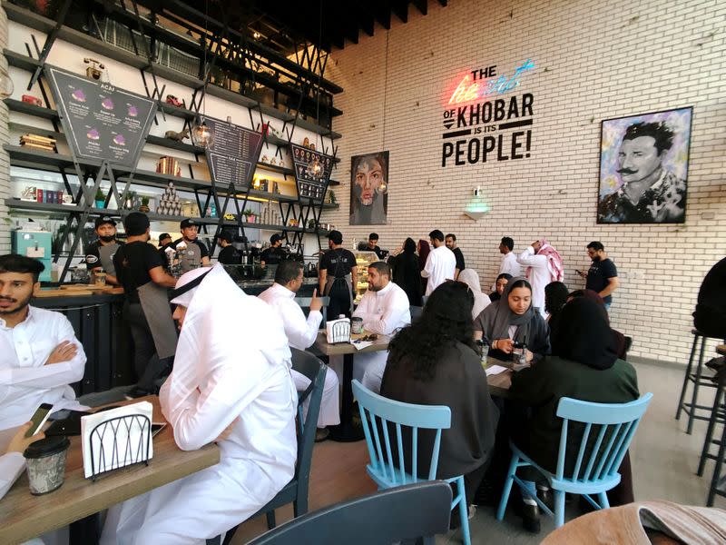 FILE PHOTO: Women sit among men in a newly opened cafe in Khobar