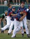 Endwell, N.Y.'s Ryan Harlost, right, begins to celebrate with teammate Jack Hopko, center, and Jude Abbadessa, left, after getting the final out of the Little League World Series Championship baseball game against South Korea in South Williamsport, Pa., Sunday, Aug. 28, 2016. New York won 2-1. (AP Photo/Gene J. Puskar)