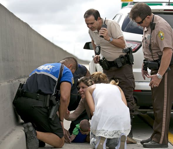 Mandatory Credit: Photo by ZUMA/REX (3588433c)Rescuers assist Pamela Rauseo, center, who performed CPR on her nephew, 5-month-old Sebastian de la Cruz, after pulling over her SUV on the side of the road along Florida state road 836. At right is Lucila Godoy, who stopped her car to assist in the rescue. At left is officer Amauris Bastidas who also stopped to the aide the baby.Baby rescued after he stops breathing on a highway, Miami, America - 20 Feb 2014This is the heart-stopping moment an aunt succsessfully performed CPR on her 5-month-old nephew on the side of a road in Miami. Pamela Rauseo was caring for her baby nephew Sebastian de la Cruz when he suddenly stopped breathing and turned blue as she drove along a highway. She leapt out of her vehicle screaming for help with little Sebastian in her arms. Several passers-by stopped, including Miami Herald photographer Al Diaz who quickly ran to alert a nearby policeman in his patrol car. The officer, Amauris Bastidasy, rushed over to help as Pamela began CPR on her nephew. Amauris and fellow Good Samaritan motorist Lucila Godoy also helped with the resuscitation efforts. The tiny youngster, who had been born prematurely, started breathing before stopping for a second time. By then paramedica had arrived and Sebastian was rushed to hospital where he is said to be recovering well.