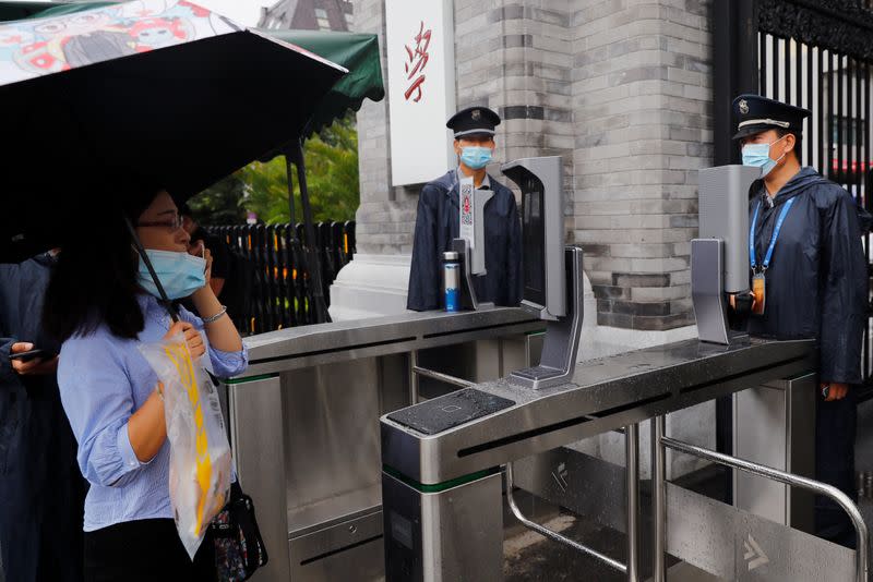 People are seen in front of facial recognition camera-controlled gates at Peking University as Chinese students gradually return to their campuses after an outbreak of the coronavirus disease (COVID-19) in Beijing, China