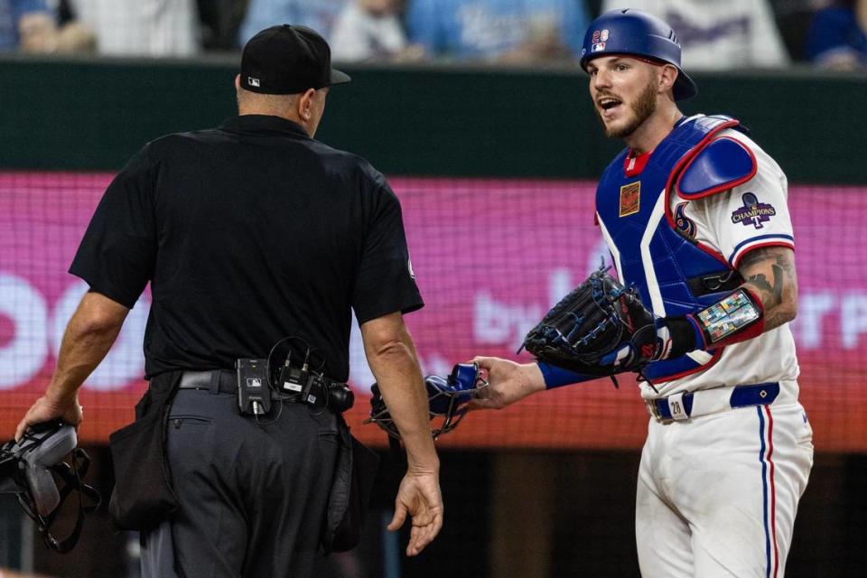 Home plate umpire Chad Fairchild argues with Texas Rangers catcher Jonah Heim after a controversial play allowed the Chicago Cubs to take the lead 3-2 in the top of the ninth inning in their season opener at Globe Life Field in Arlington on Thursday, March 28, 2024. Fairchild ruled that the Cub’s Mastrobuoni swung and missed when it was foul tipped and got past Heim. This allowed Cub’s Michael Busch to take advantage and advance to third base and eventually to home plate. Chris Torres/ctorres@star-telegram.com