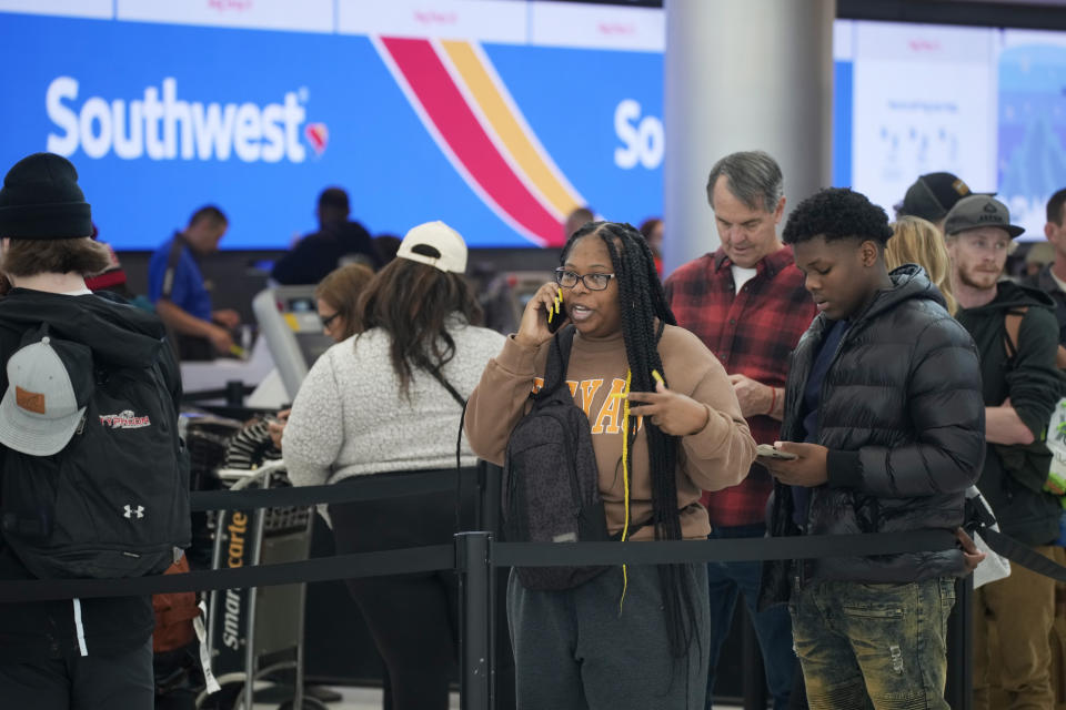 FILE, Travelers wait on line for service at the Southwest Airlines check-in counter in Denver International Airport, Tuesday, Dec. 27, 2022, in Denver. With its flights now running on a roughly normal schedule, Southwest Airlines is turning its attention to luring back customers and repairing damage to a reputation for service after canceling 15,000 flights around Christmas. The disruptions started with a winter storm and snowballed when Southwest's ancient crew-scheduling technology failed.(AP Photo/David Zalubowski, File)