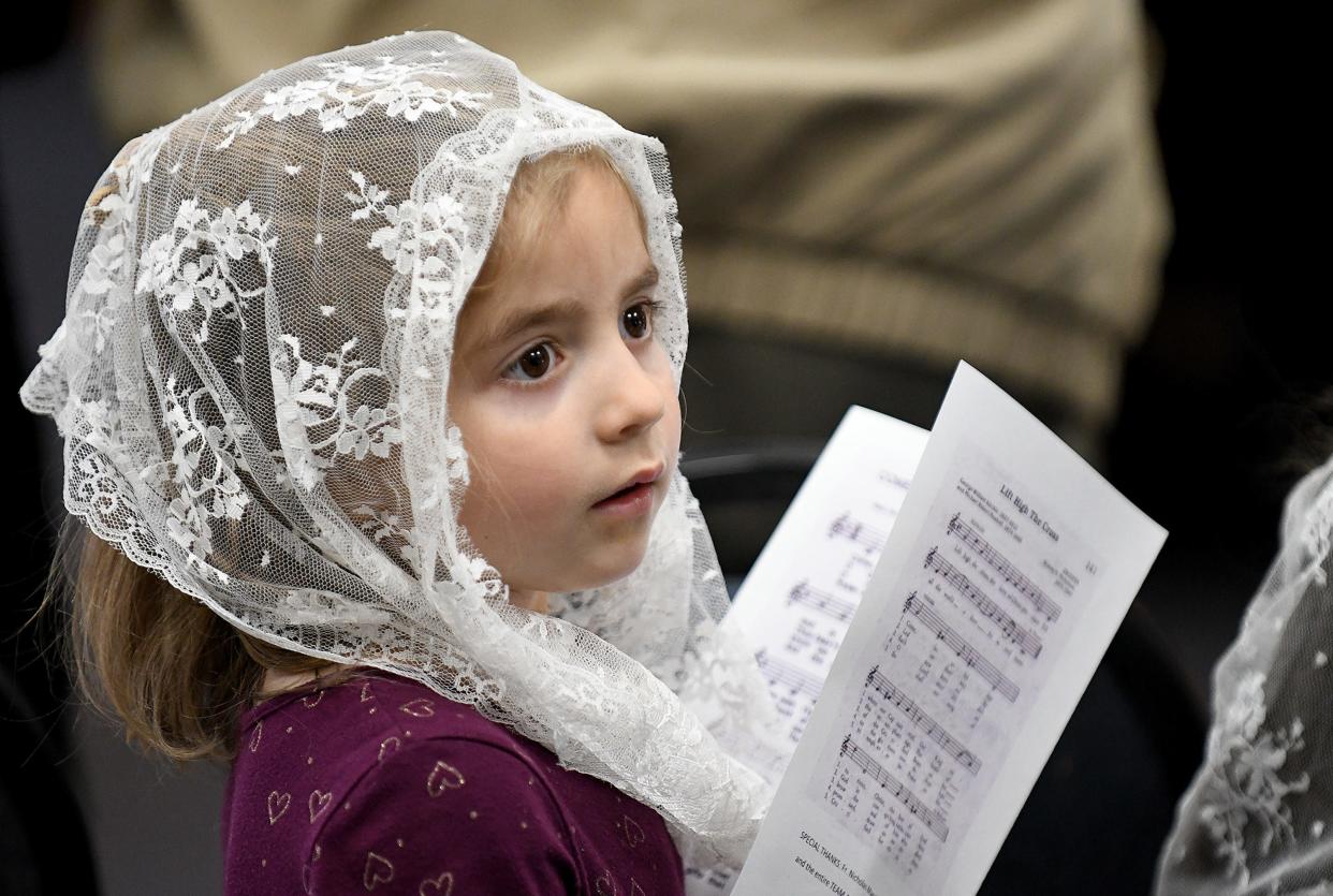 Jean Marie Scott, 4, of Canal Fulton helps to celebrate the birthday of Mother Angelica with a Mass and dedication of a monument at the St. Raphael Center in Jackson Township.