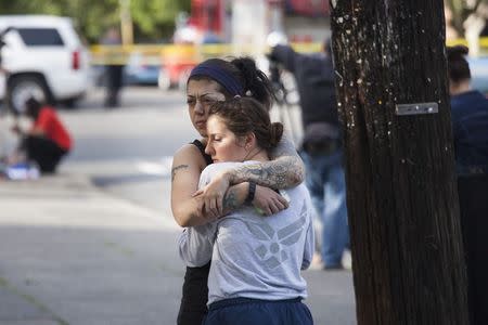 Rana Levy (L) hugs Christine Smith (R) at Seattle Pacific University after a shooting on the campus that left their friends injured in Seattle, Washington June 5, 2014. REUTERS/David Ryder