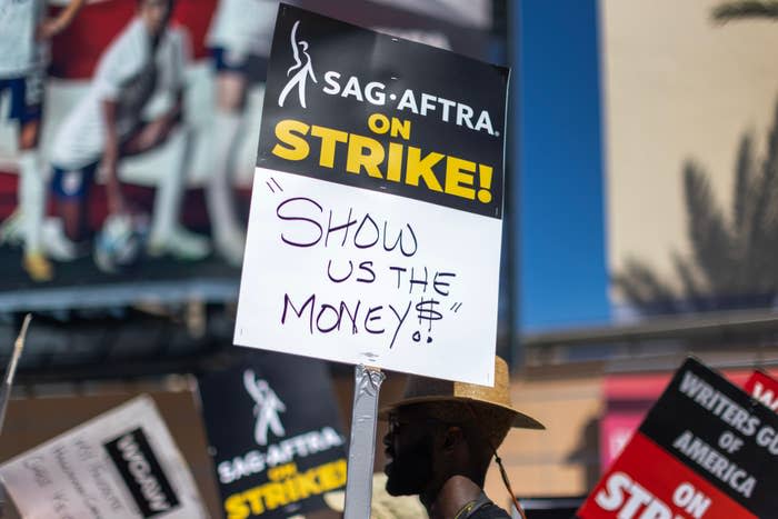 Close-up of a sign on the picket line: "Show us the money!" with a dollar sign