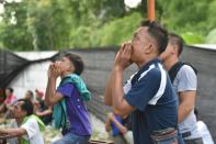 Bird owners shout during a bird singing contest in Indonesia, where a nationwide craze known as "chirping mania" is blamed for the dwindling of songbirds in the wild