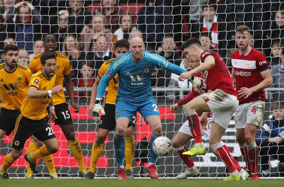 Wolverhampton goalkeeper John Ruddy, center, eyes the ball during the English FA Cup fifth round soccer match between Bristol City and Wolverhampton Wanderers at Ashton Gate stadium in Bristol, England, Sunday, Feb. 17, 2019. (AP Photo/Frank Augstein)