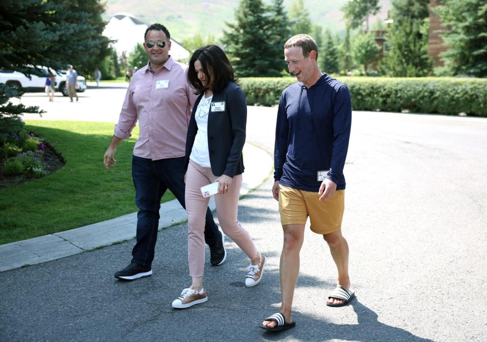 Mark Zuckerberg walking with 2 others