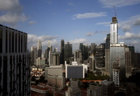 FILE PHOTO: GuocoLand Ltd's mixed-use Tanjong Pagar Centre, soon to be the tallest building in the city-state, towers over other buildings in the central business district of Singapore