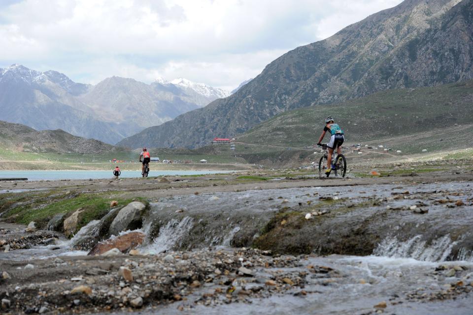 International and local Pakistani cyclists compete during the second stage of the Himalayas 2011 International Mountainbike Race in the mountainous area of Lake Saif-ul-Maluk in Pakistan's tourist region of Naran in Khyber Pakhtunkhwa province on September 17, 2011. The cycling event, organised by the Kaghan Memorial Trust to raise funds for its charity school set up in the Kaghan valley for children affected in the October 2005 earthquake, attracted some 30 International and 11 Pakistani cyclists. AFP PHOTO / AAMIR QURESHI (Photo credit should read AAMIR QURESHI/AFP/Getty Images)