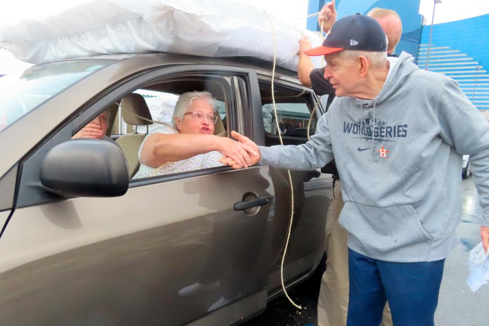 mattress mack's jim micingvale shaking a woman's hand