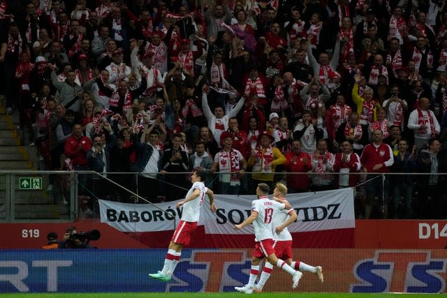 Robert Lewandowski, left, celebrates after scoring in the qualifier win over Albania