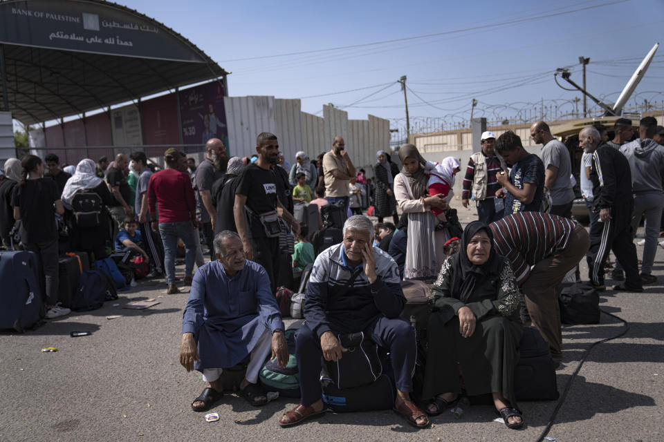Palestinians wait to cross into Egypt at the Rafah border crossing in the Gaza Strip on Monday, Oct.16, 2023. (AP Photo/Fatima Shbair)