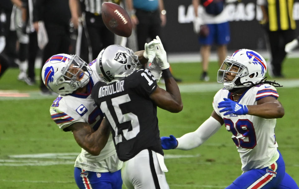 Buffalo Bills free safety Jordan Poyer, left, and cornerback Josh Norman, right, guard Las Vegas Raiders wide receiver Nelson Agholor (15) during the second half of an NFL football game, Sunday, Oct. 4, 2020, in Las Vegas. Poyer was called for pass interference on the play. (AP Photo/David Becker)