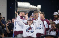 Colorado Avalanche defenseman Bowen Byram lifts the Stanley Cup during a rally outside the City/County Building for the NHL hockey champions after a parade through the streets of downtown Denver, Thursday, June 30, 2022. (AP Photo/David Zalubowski)