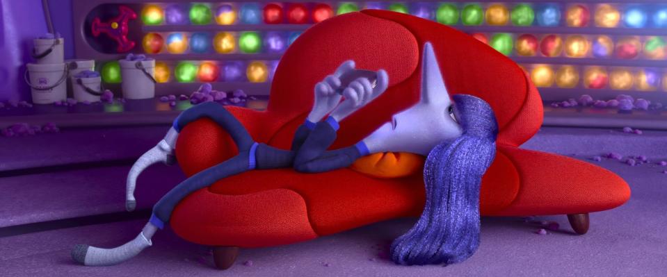 Ennui lying on a red sofa in a scene from Inside Out 2