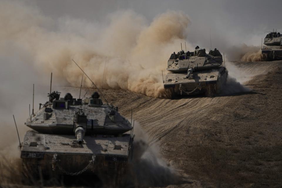 FILE - Israeli tanks head towards the Gaza Strip border in southern Israel on Friday, Oct. 13, 2023. The war between Israel and Hamas has brought carefully calibrated condemnations and warnings to both sides by Russia. (AP Photo/Ariel Schalit, File)