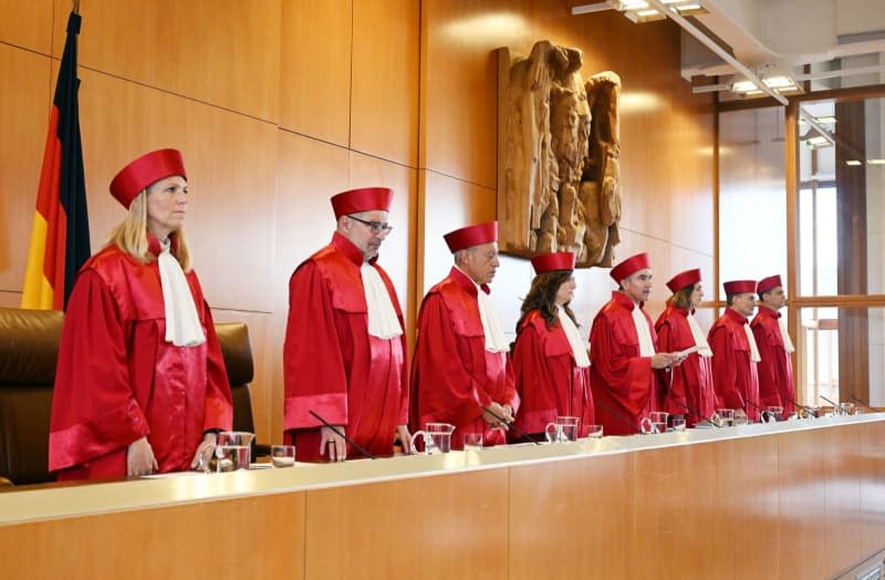 (LR) The First Senate of the Federal Constitutional Court, Miriam Meßling, Heinrich Amadeus Wolff, Josef Christ, Ines Härtel, Stephan Harbarth (Chairman of the Senate and President of the Court, Yvonne Ott, Henning Radtke and Martin Eifert, make the ruling known on the "Federal Criminal Investigation Act - Data platforms". Germany's Constitutional Court ruled on Tuesday that some of the methods used by the country's police to collect and store data are unconstitutional. Uli Deck/dpa