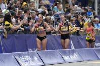 American runners, from the left, Sara Hall, Emma Bates, and Des Linden, greet the crowd after finishing the Boston Marathon, Monday, April 15, 2024, in Boston. (AP Photo/Steven Senne)