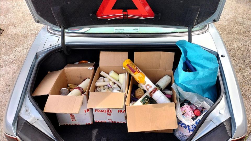 The car boot of Reverend Will Lyon Tupman, on another candle run