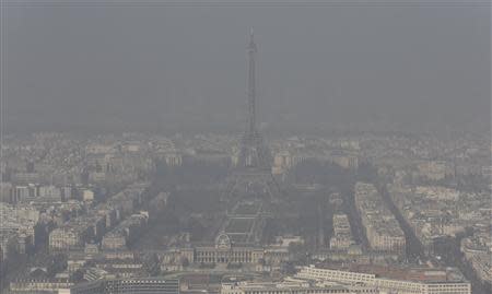 A general view shows the Eiffel tower and the Paris skyline through a small-particle haze March 13, 2014 as warm and sunny weather continues in France. Residents and visitors to Paris basking in a streak of unseasonable sunshine were also being treated with a dangerous dose of particles from car fumes that pushed air pollution to levels above other northern European capitals this week. REUTERS/Philippe Wojazer