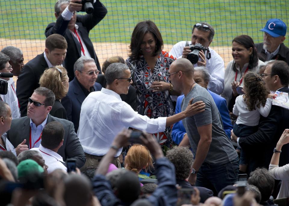 FILE - In this March 22, 2016, file photo, U.S. President Barack Obama, center left, introduces former New York Yankees great Derek Jeter, center right, to Cuba's President Raul Castro, left of Obama, as first lady Michelle Obama, center, watches, at the start of a baseball game between the Tampa Bay Rays and Cuba's national baseball team, at Estadio Latinoamericano in Havana, Cuba. Obama's foreign policy legacy may be defined as much by what he didn't do as what he did. (AP Photo/Rebecca Blackwell, File)