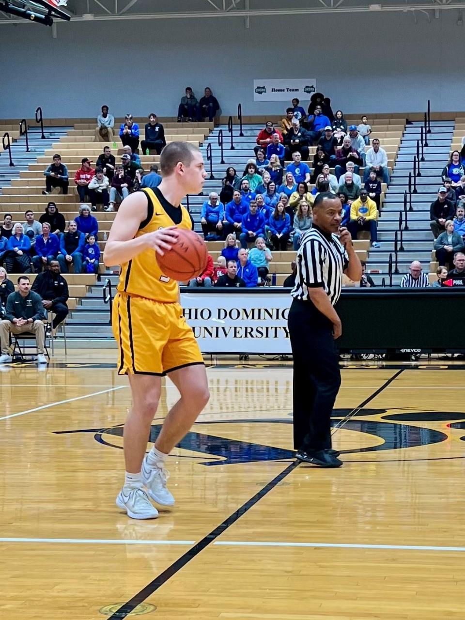 Northmor's Jax Wenger dribbles the ball up the court during Friday's Division IV boys basketball district championship game at Ohio Dominican.