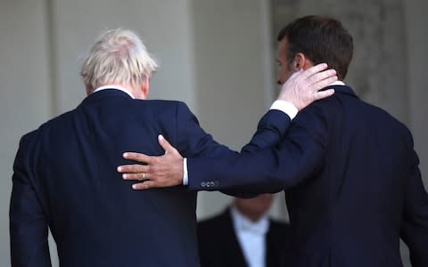 French President Emmanuel Macron (right) and Britain’s Prime Minister Boris Johnson walk into the Elysee Palace after addressing the press - Credit: &nbsp;Daniel Cole/&nbsp;AP