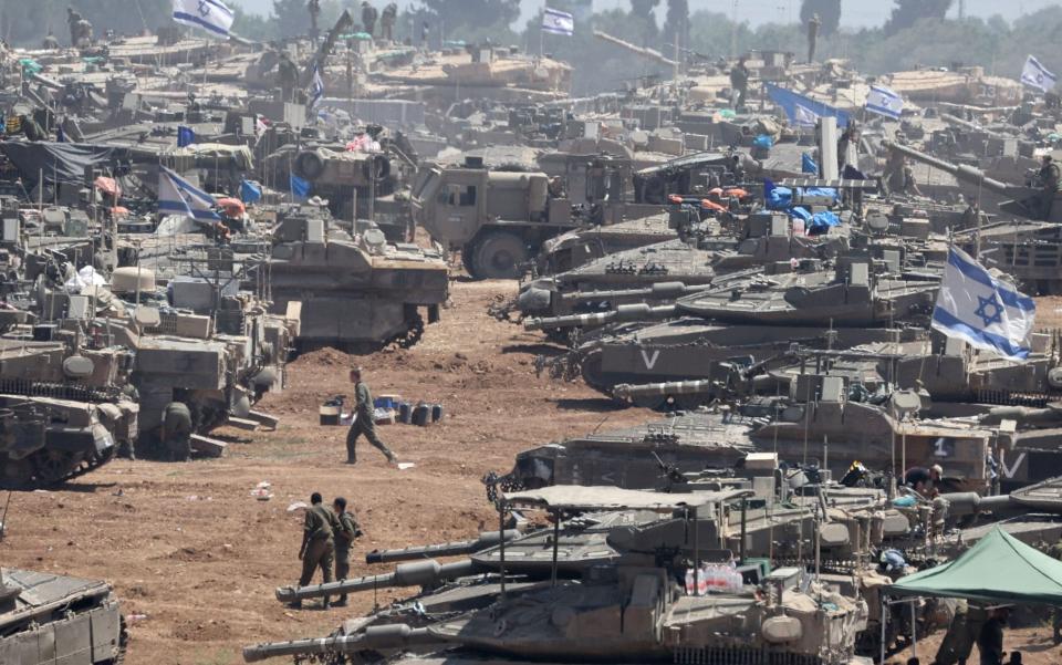 Israeli soldiers with military vehicles near the Gaza Strip border in southern Israel, on Thursday