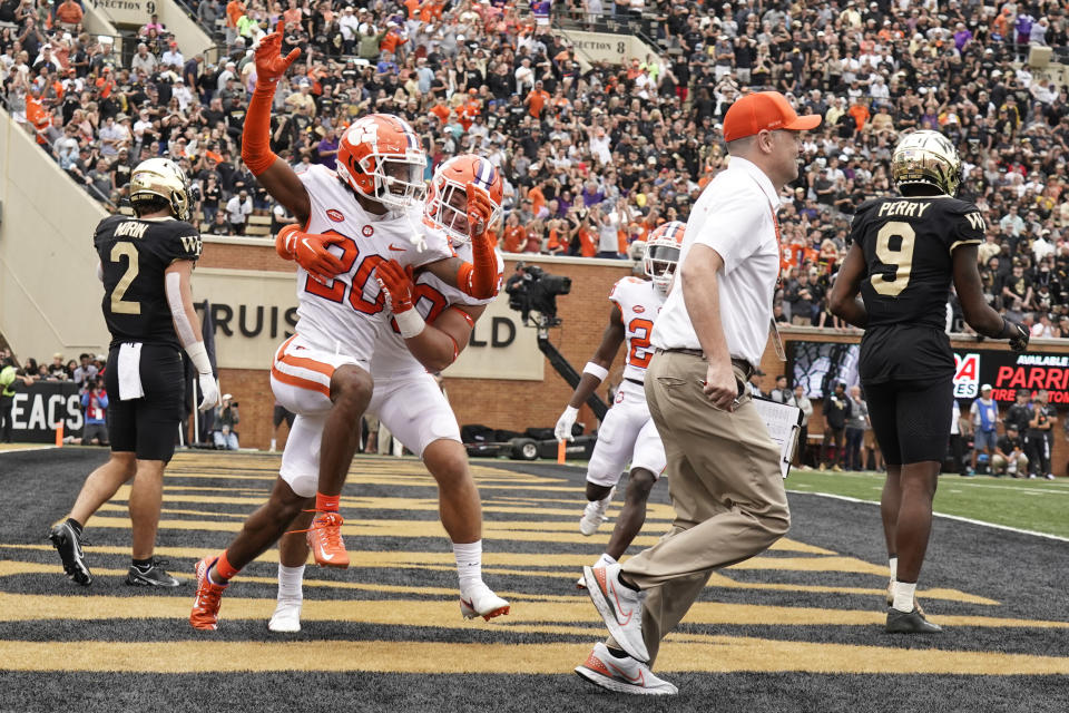 Clemson cornerback Nate Wiggins (20) is congratulated by teammate Keith Maguire (30) after knocking down a fourth down pass intended for Wake Forest wide receiver A.T. Perry (9) during the second overtime of an NCAA college football game in Winston-Salem, N.C., Saturday, Sept. 24, 2022. Clemson won 51-45 in double overtime. (AP Photo/Chuck Burton)