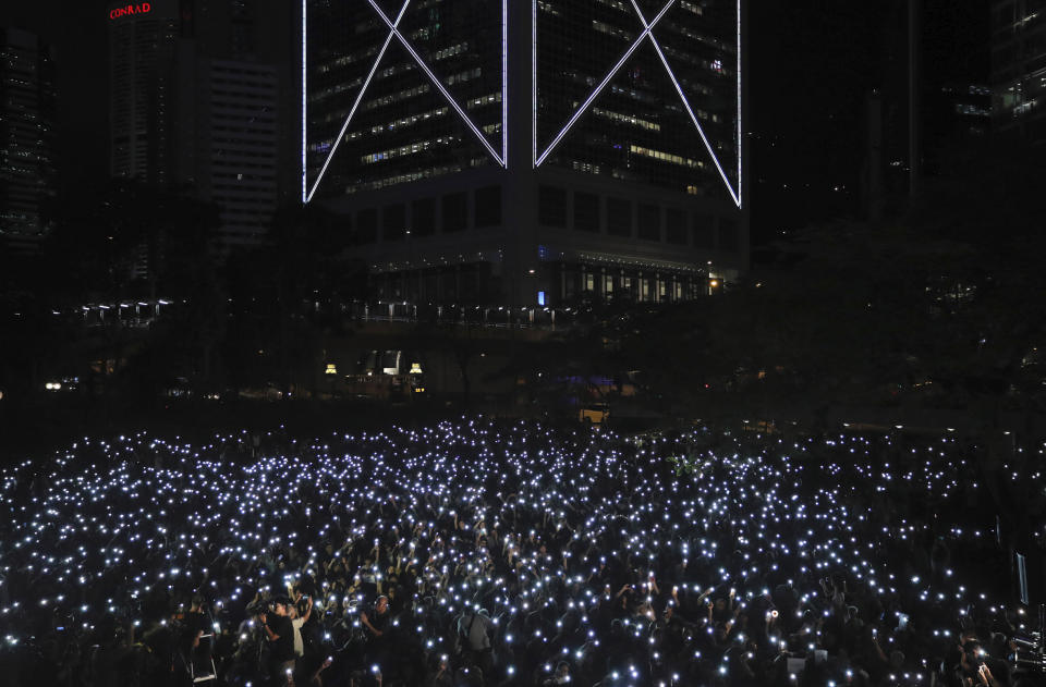 Attendees light up their mobile phones during a rally by mothers in Hong Kong on Friday, July 5, 2019. Student unions from two Hong Kong universities said Friday that they have turned down invitations from city leader Carrie Lam for talks about the recent unrest over her proposal to allow the extradition of suspects to mainland China. (AP Photo/Kin Cheung)