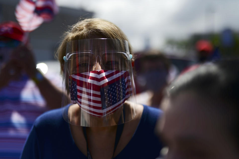 Supporters of President Donald Trump gather moments before leaving for the headquarters of the Republican party in support of his candidacy a few weeks before the presidential election next November, in Carolina, Puerto Rico, Sunday, Oct. 18, 2020. President Donald Trump and former Vice President Joe Biden are targeting Puerto Rico in a way never seen before to gather the attention of tens of thousands of potential voters in the battleground state of Florida. (AP Photo/Carlos Giusti)