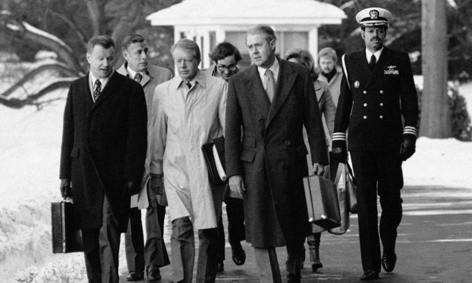 Zbigniew Brzezinski, left, with Jimmy Carter, centre in raincoat, and Cyrus Vance in 1979.