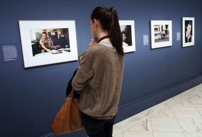 A visitor reflects on a photograph of rock icon Bruce Springsteen by Annie Leibovitz at a February 5, 2014 press preview of the "American Cool" exhibition at the National Portrait Gallery in Washington, DC