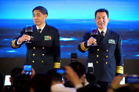 Vice Admiral Shen Jinlong, commander of the Chinese People's Liberation Army (PLA) Navy, and Vice Admiral Qin Shengxiang, political commissar of the PLA Navy, give a toast at a welcome reception for the commemoration of the 70th anniversary of the founding of the China's navy in Qingdao, Shandong province, China, April 22, 2019. Mark Schiefelbein/Pool via REUTERS