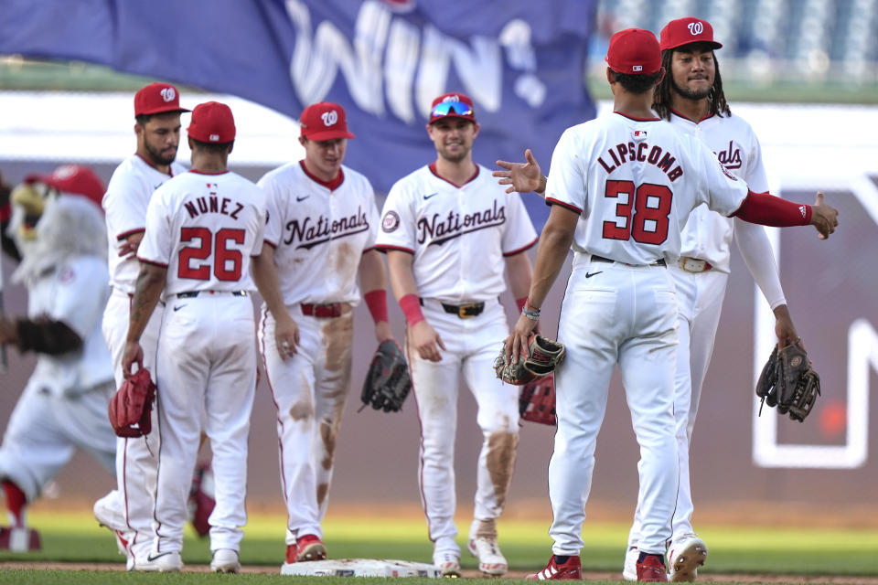 Washington Nationals left fielder James Wood, right, is congratulated by third baseman Trey Lipscomb (38) after a baseball game against the St. Louis Cardinals at Nationals Park, Saturday, July 6, 2024, in Washington. The Nationals beat the Cardinals, 14-6. (AP Photo/Mark Schiefelbein)