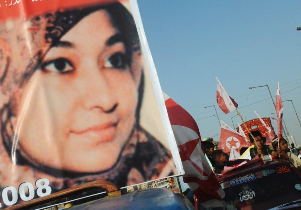 File Supporters of US-detained Pakistani woman Aafia Siddiqui carry flags and placards with her portrait during an anti-US demonstration in Karachi on 28 March, 2010 (AFP via Getty Images)