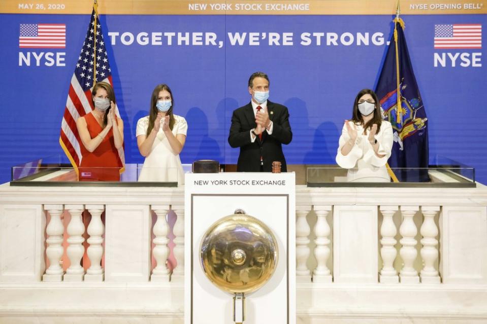 New York State Governor Andrew Cuomo, centre, applauds as he rings the opening bell of the New York Stock on May 26, 2020. Source: AP