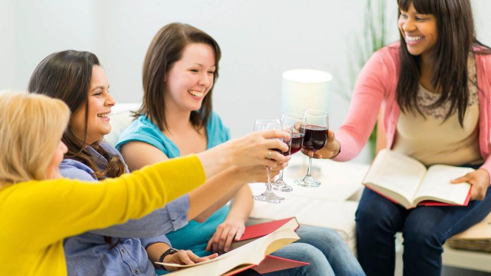 friends drinking wine in book club