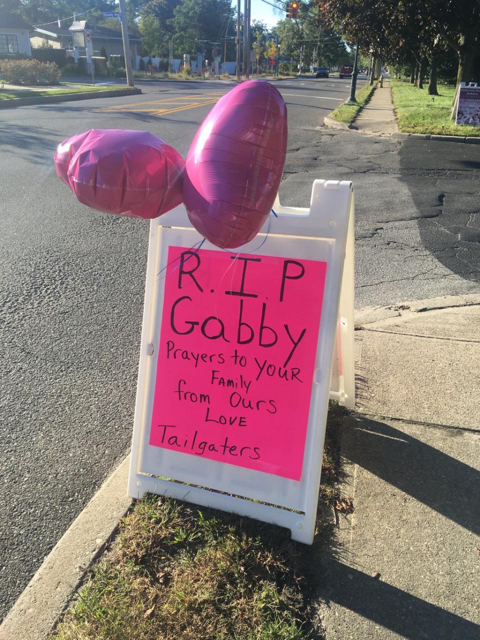 The Tailgaters bar in Holbrook, Long Island, left a tribute to Ms Petito on the side of the road near the memorial service (Bevan Hurley/The Independent)